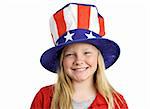 A pretty blond little girl smiling in a stars and stripes hat for Fourth of July.  Isolated on white.