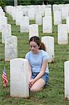 a young girl mourning a fallen soldier in a graveyard