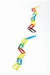 chain of colored clips over white background