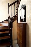 Wooden staircase and beautiful mirror in the modern house