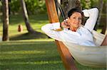 20-25 years woman portrait ralaxing on hammock at exotic surrounding, bali indonesia