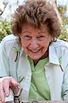 A beautiful senior woman taking a drink of water from a water fountain.