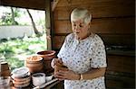 A senior lady gardening in her potting shed.