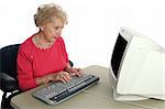 A senior lady confused by the computer.  Screen intentionally blank ready for content.