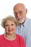 An attractive senior couple against a white background.  Vertical orientation.