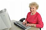 A happy, smiling senior woman using the computer.