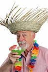 A senior man on a tropical vacation enjoying a margarita.
