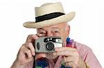 A senior man on vacation snaping photographs.