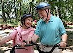 A happy senior couple staying fit by bicycling together.