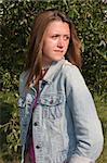 a beautiful girl in denim, looking over her shoulder