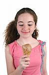 A cute teen girl eating a chocolate ice cream cone. Isolated