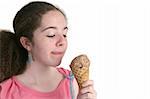 A teen girl enjoying a chocolate ice cream cone.