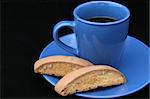 Coffee & Biscotti on a black background.