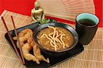 A delicious Chinese dinner of hot & sour soup, fried shrimp and tea.