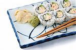 A delicious sushi, california roll with ginger and wasabe on a white background.