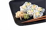A sushi california roll on a black plate, partial view  isolated. (plate texture may resemble artifacts)