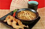 A bowl of hot & sour soup with chow mein noodles, fried fantail shrimp and hot tea.
