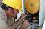 An air conditioning repairman testing a heat recovery unit.