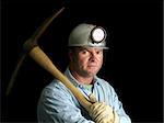 A coal miner with his pickax, in the darkness of a mine shaft.