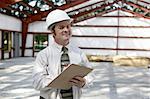 A construction inspector satisfied with his inspection of a steel framed building.