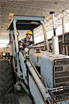 A construction worker operating a backhoe.