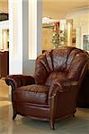 Beautiful leather armchair in a modern furniture store