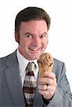 A businessman smiling as he gets ready to eat a chocolate ice cream cone.