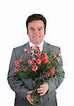 A handsome husband in a suit holding a bouquet of pink sweetheart roses over a pink packground.