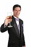 A handsome man in a tuxedo making a toast with champagne.