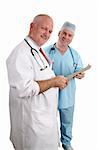 A vertical view of two friendly doctors reviewing a medical chart.  Isolated. (focus on doctor in white coat)