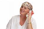 A woman, bald from medical treatment, receiving good news by telephone.