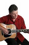 A handsome professional musician performing a song on his guitar.  He is concentrating on his music. Isolated.