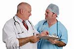 An older doctor instructs an intern as they discuss a patient's medical history.  Isolated.