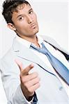 Studio portrait of mixed race young man looking threathening