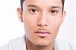Studio portrait of mixed race young man looking neutral