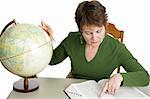 A librarian or adult student doing geography research using a globe.  Isolated on white.  Note to inspector:  Texture of green shirt may appear as artifacting.
