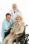 Senior lady in wheelchair with her doctor and nurse.  Isolated on white.