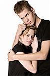 Couple of teenagers in the studio on a white background in love