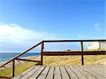 Photograph of a wooden walkway leading down to the beach