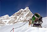 Snow-gun on a ski slope , mountain ski resort