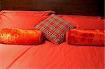 Red and beige bedding sheets and pillows