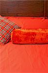 Red and beige bedding sheets and pillows