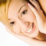 Studio portrait of a young blond woman acting funny