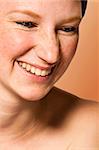 Studio portrait of a young woman with short hair in laughs