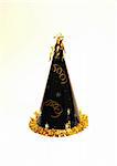 A black and gold party hat ready for a celebration.