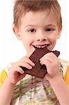 The boy eats a greater chocolate