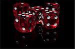 Five red casino dice on the black background