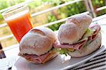 Ham and cheese sandwich on portuguese rolls served with juice