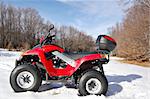 red quad bike in snow mountain scenery