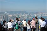 Tourists sightseeing the Hong Kong skyline at the Peak